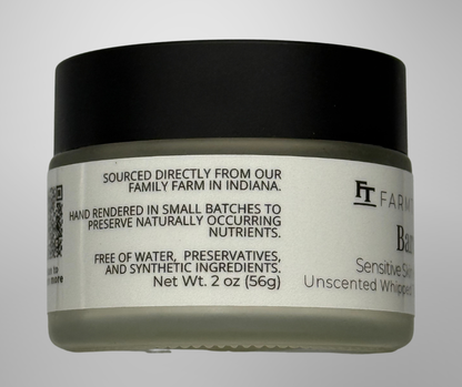 Jar of unscented whipped butter with black lid and white label on a gray background