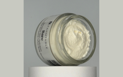 Jar of cream with a white lid on a gray background