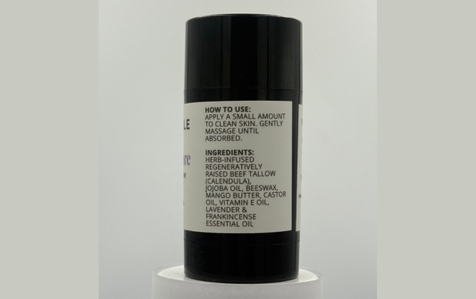 Black cylindrical container with a label on a white background