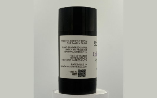 Black cylindrical container with a label on a gray background