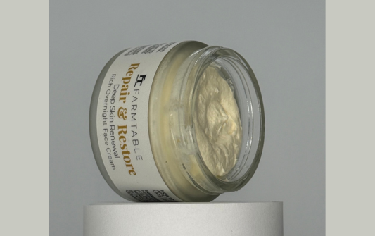 Jar of repair cream on a gray background
