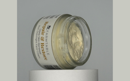 Jar of repair cream on a gray background