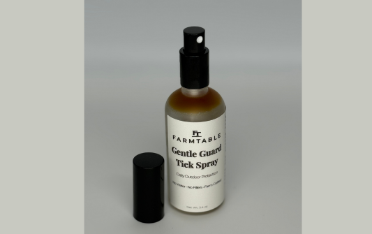 Farmtable Gentle Guard Tick Spray bottle on a gray background