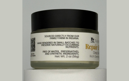 Jar of repair cream with a black lid on a gray background