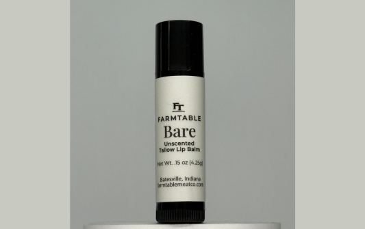 Farmtable Bare lip balm on a gray background
