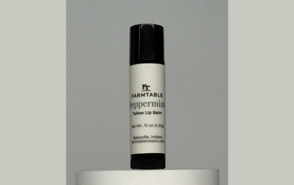 Lip balm with 'Farmtable' branding on a gray background