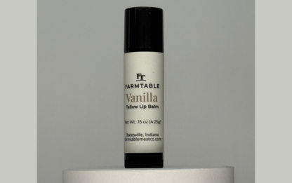 Vanilla lip balm with 'Farmland' branding on a gray background
