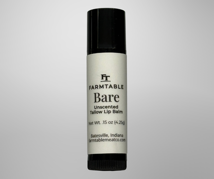 Farmtable Bare unscented tallow lip balm on a gray background