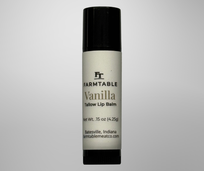 Vanilla lip balm with black cap and white container on a gray background