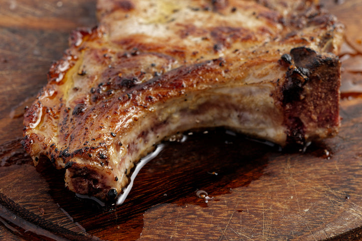 Grilled rib on a wooden cutting board
