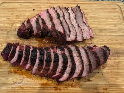 Sliced tri tip on a wooden cutting board
